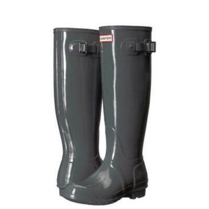 Hunter tall, grey, glossy rain boots.